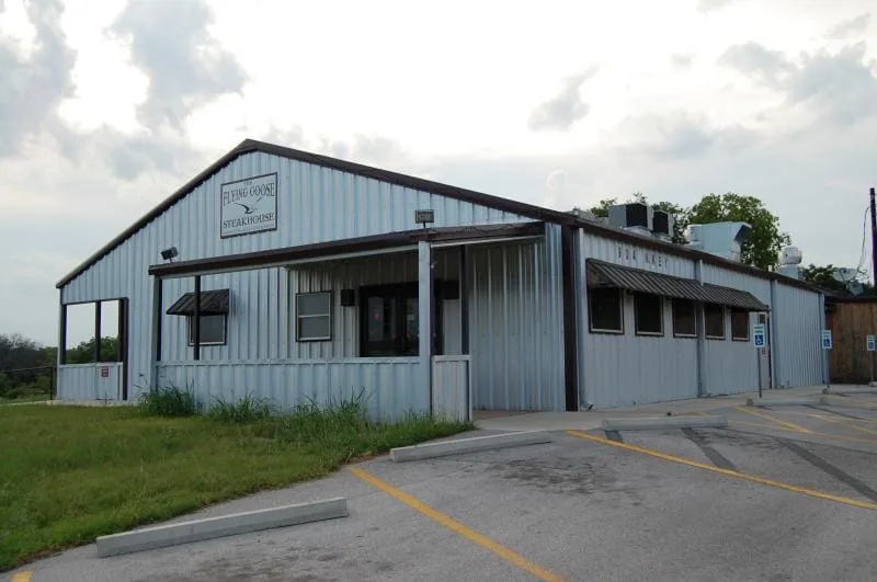 Front of the restaurant building with metal roof and entry awning.