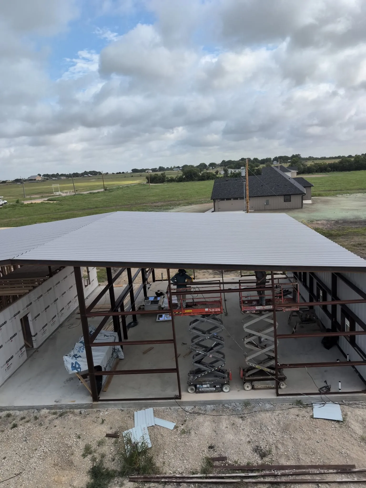 View across the metal roof above the home's framed interior.