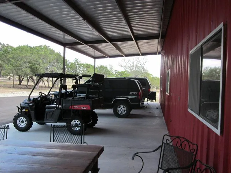 Covered parking bay with room for utility vehicles.
