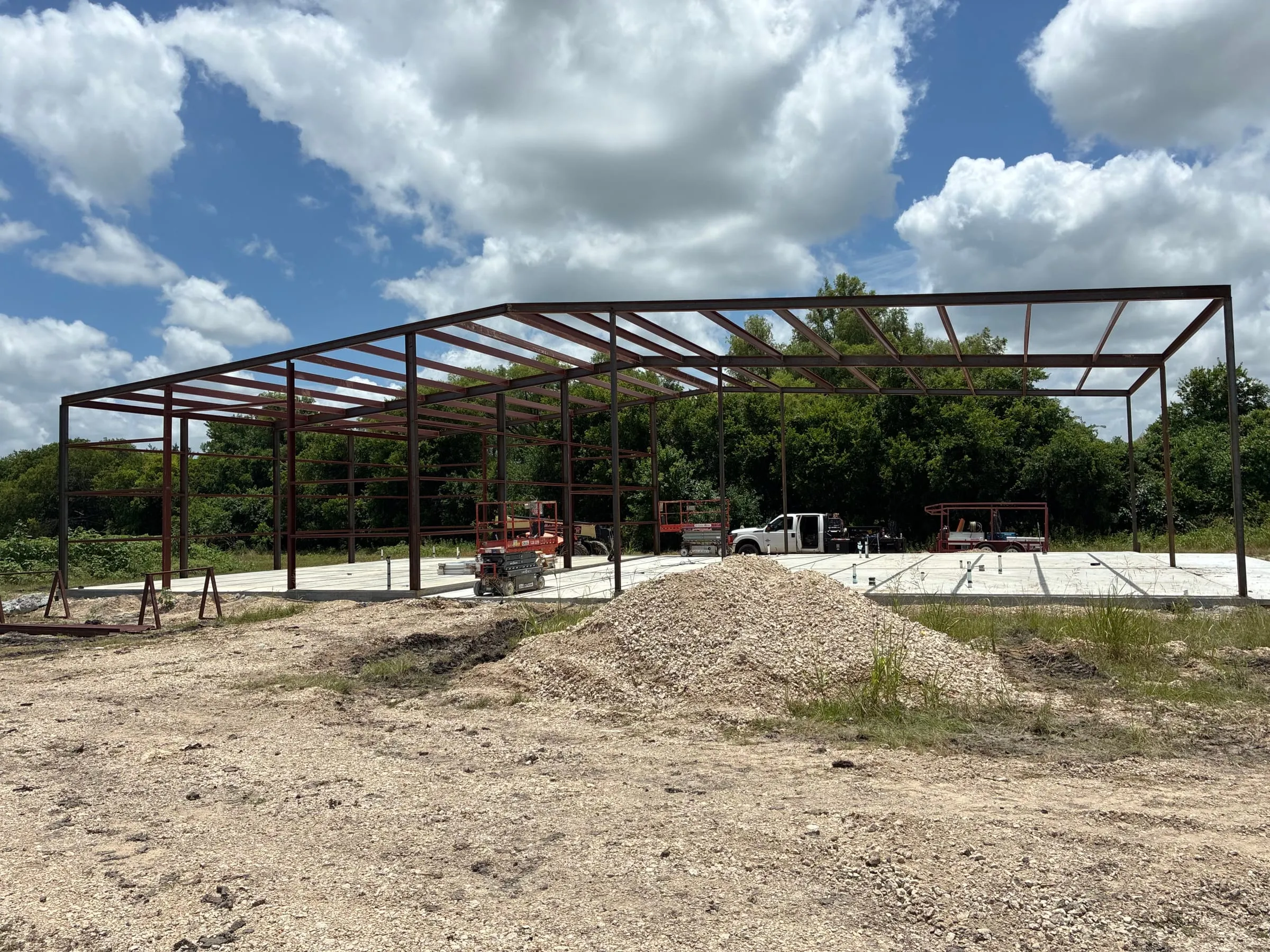 Wide view of the steel home frame during early erection.