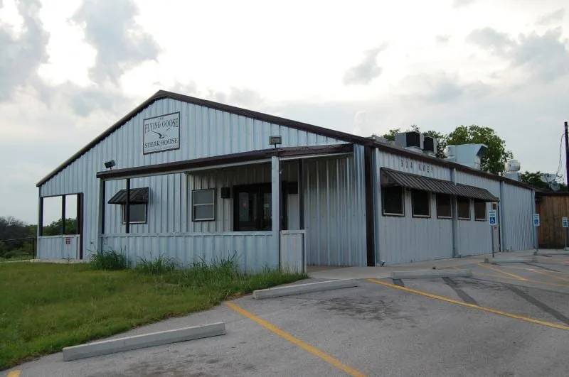 Flying Goose restaurant building with a metal roof and covered porch.